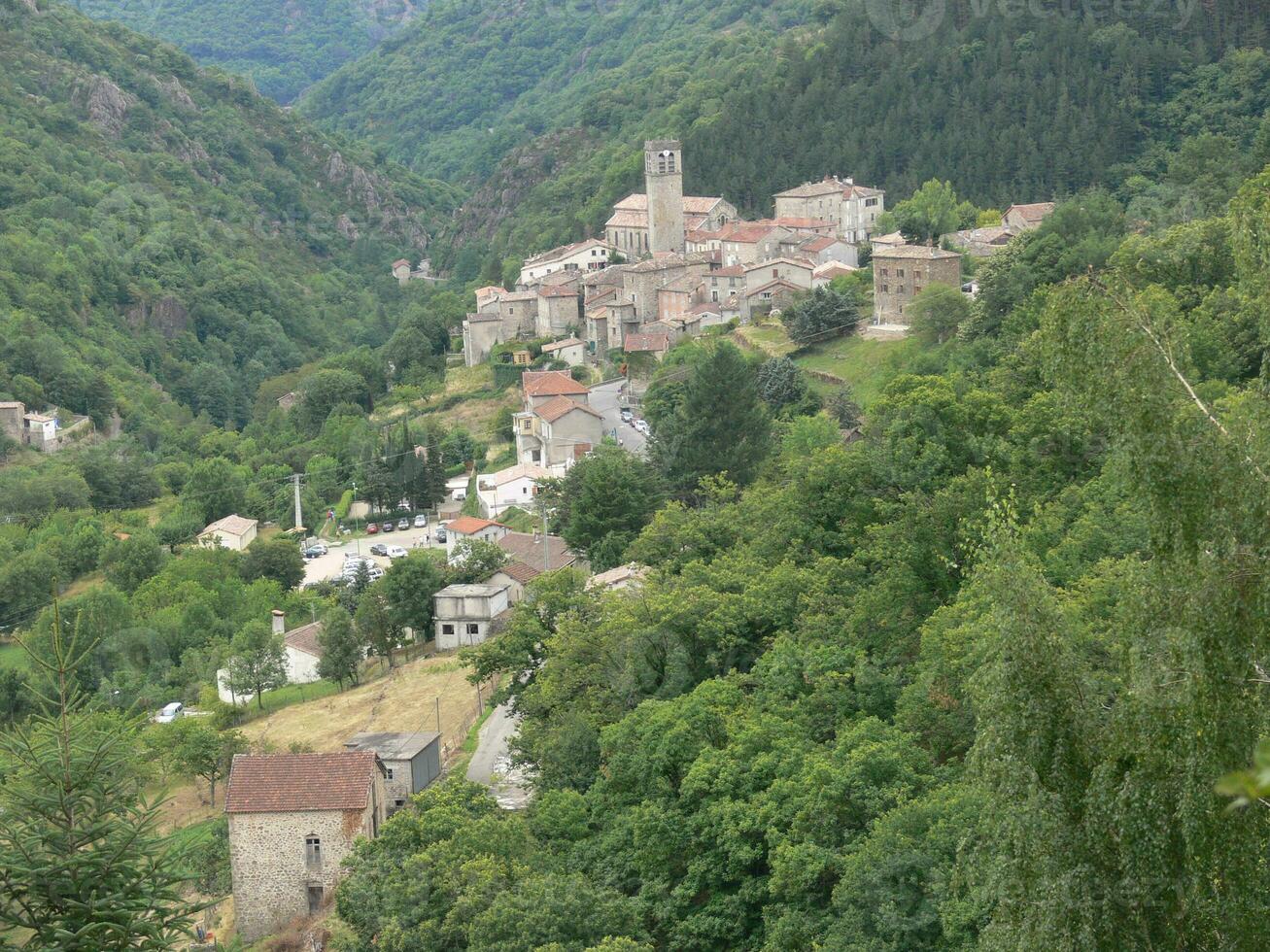 a small town surrounded by trees photo