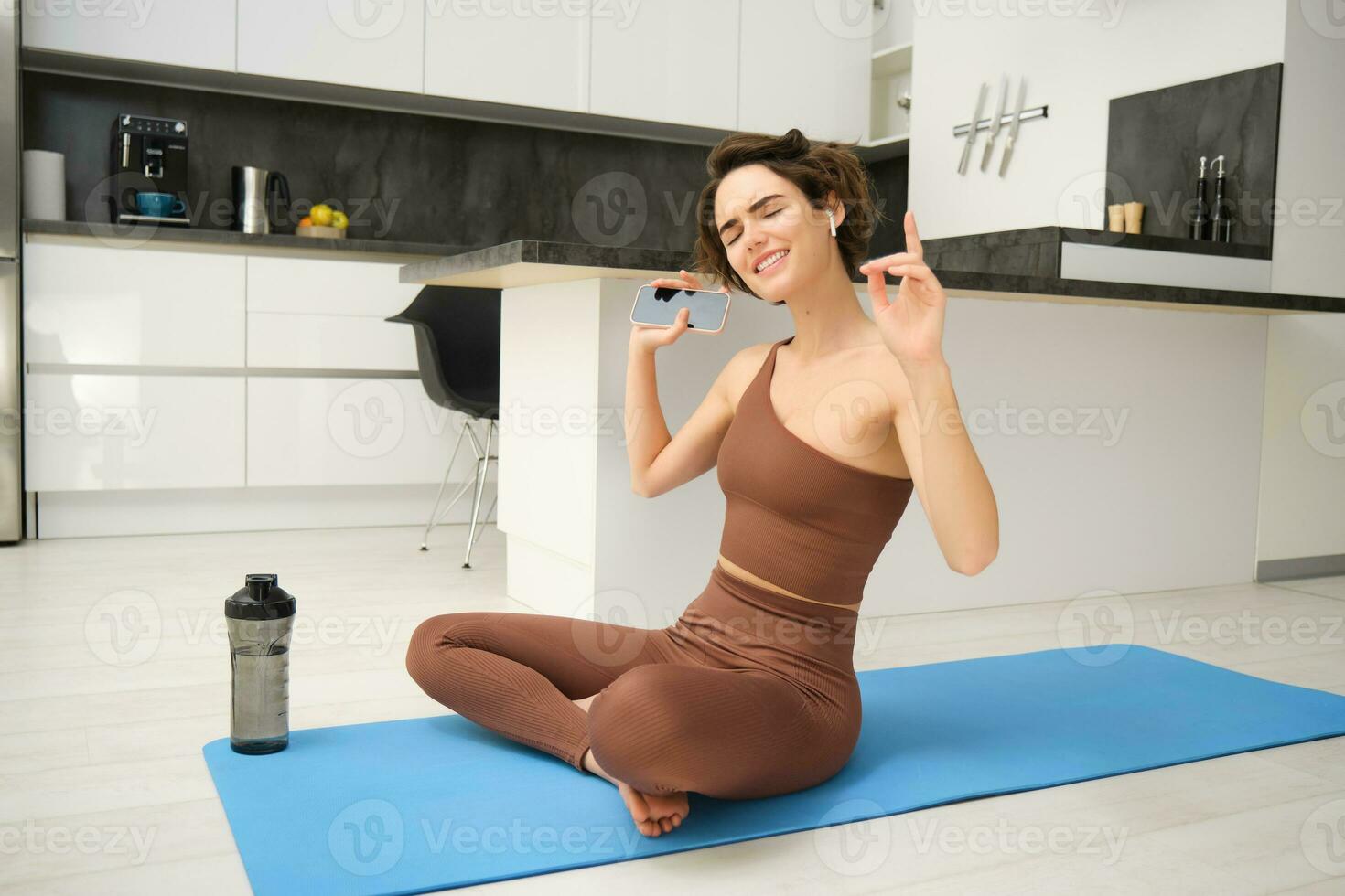 Active lifestyle and health. Happy young woman does workout, sits