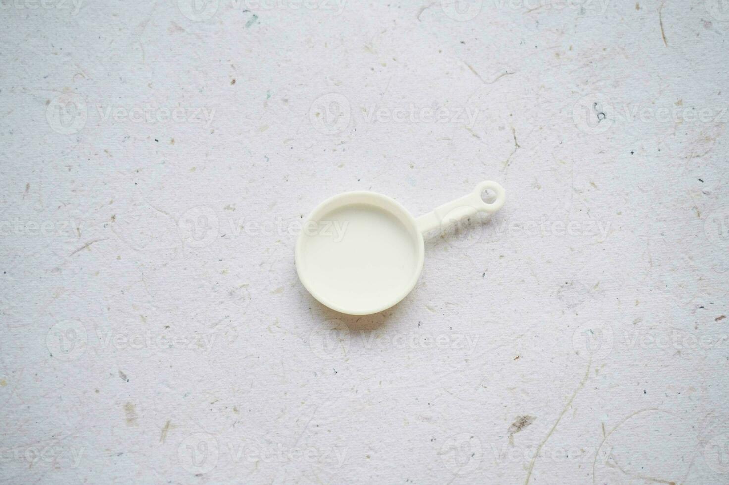 Miniature kitchen utensils on a white background, top view, copy space for text photo