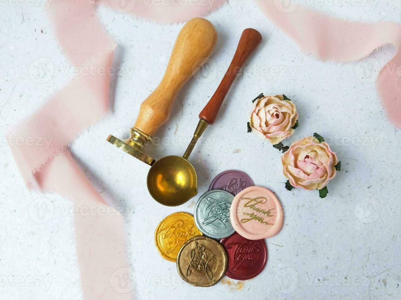 Colorful wax seal stamps and wax bead on a white background photo