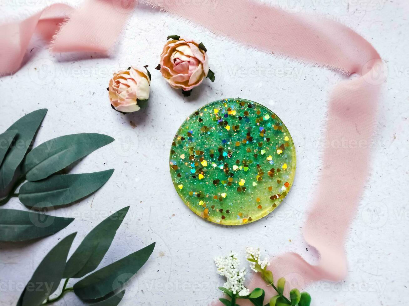 flat lay composition of resin and wood coaster on grey background photo