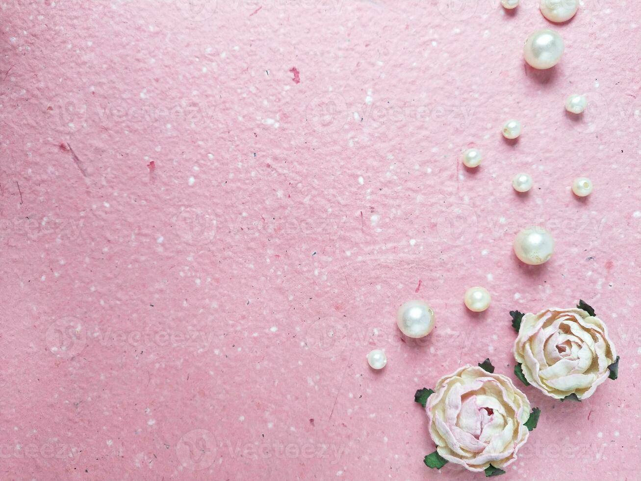 Pink background with pearls and roses. Top view with copy space photo