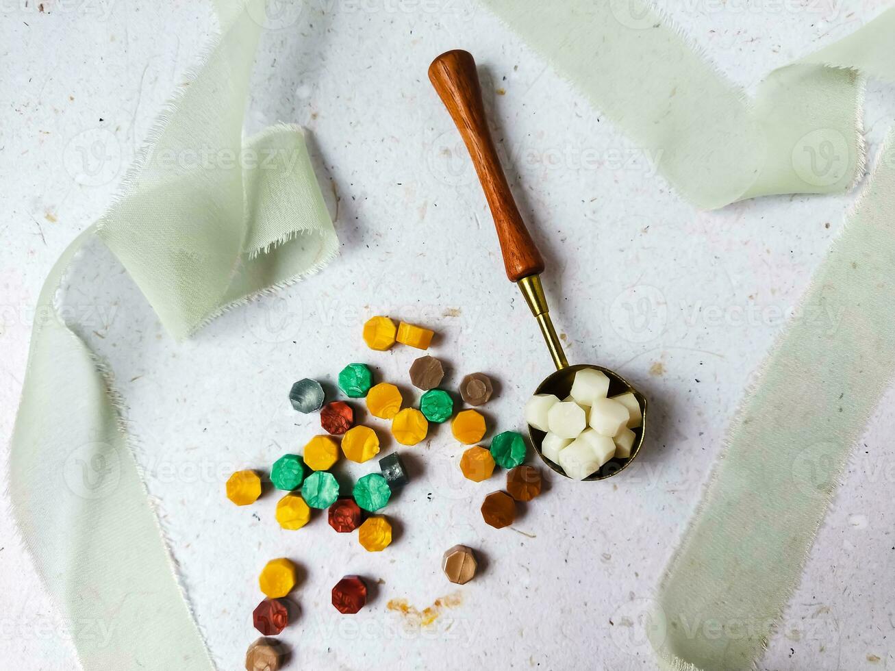 Colorful wax seal stamps and wax bead on a white background photo