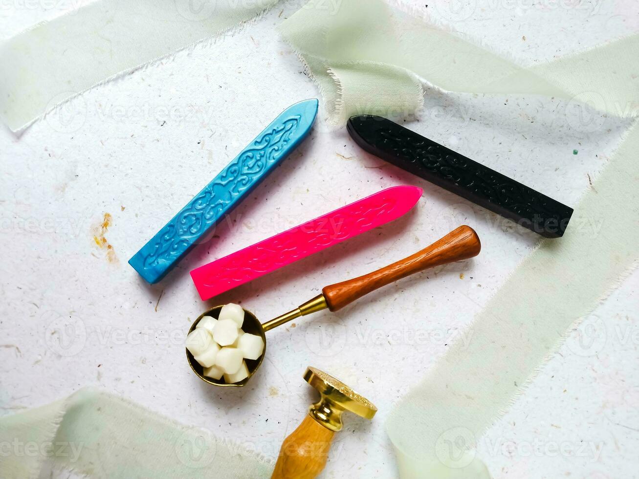 Colorful wax seal stamps and wax bead on a white background photo