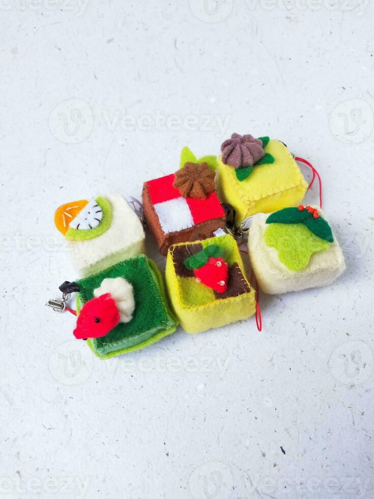 a closeup shot of handmade felt woolen toy on a white background. Selective focus. photo