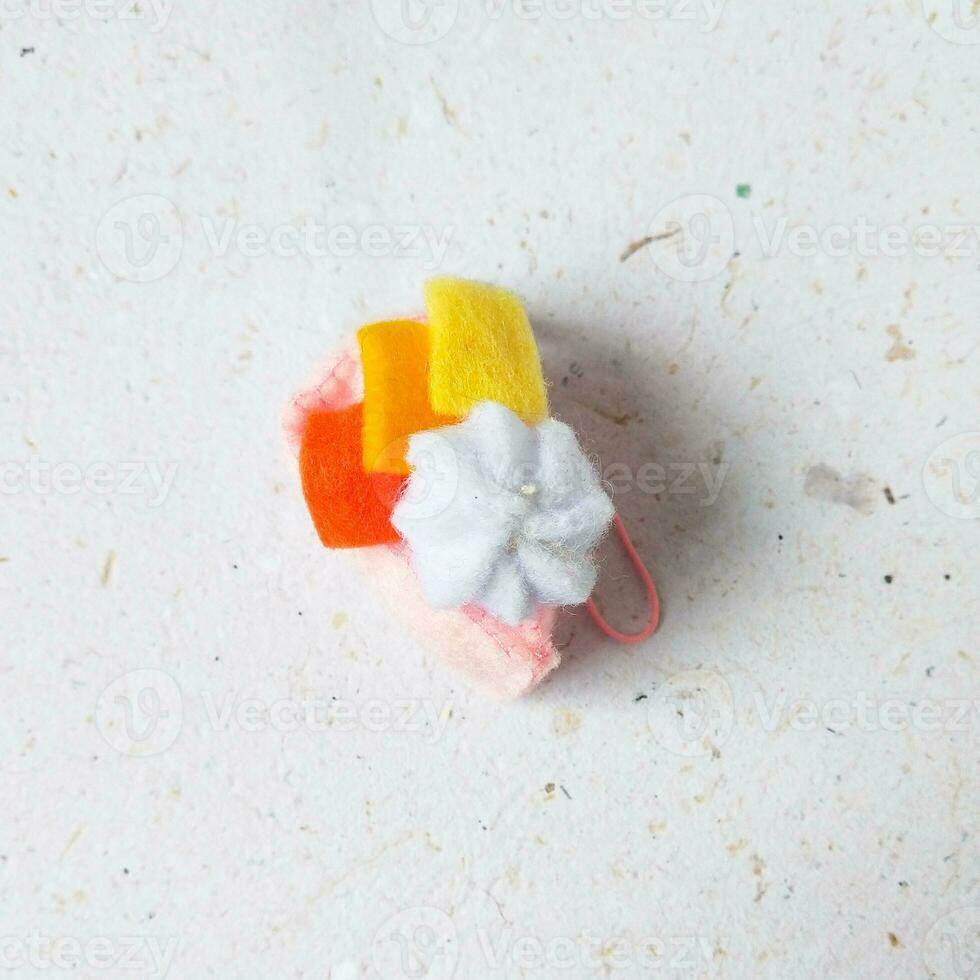 a closeup shot of handmade felt woolen toy on a white background. Selective focus. photo