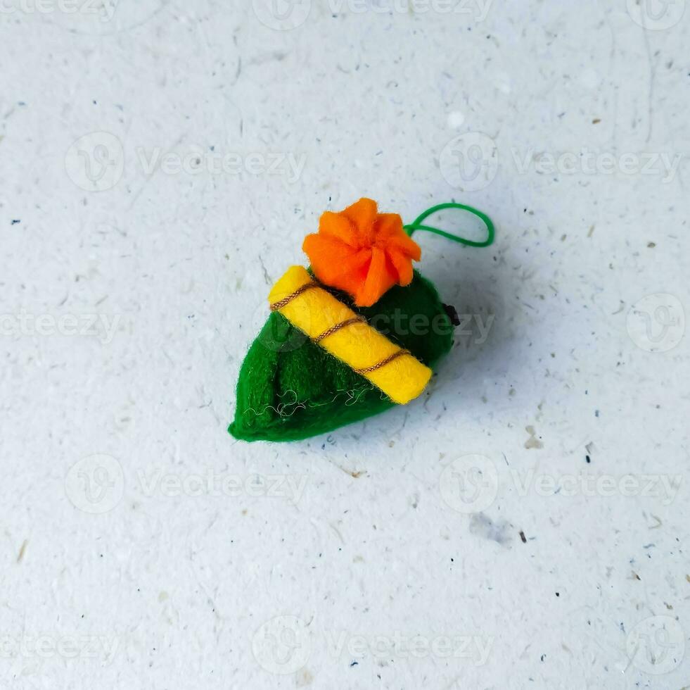 a closeup shot of handmade felt woolen toy on a white background. Selective focus. photo