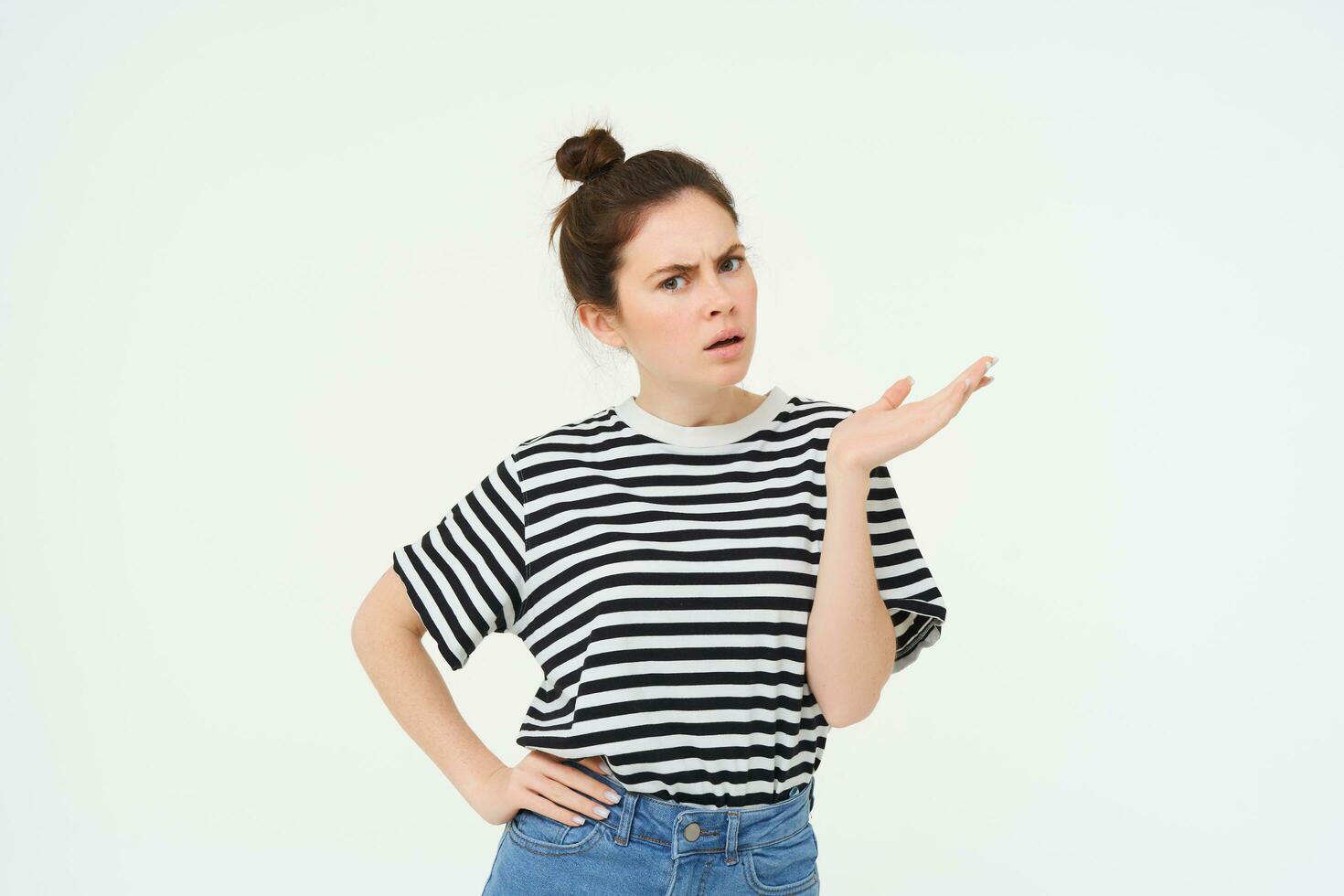 Portrait of angry woman complaining, raising one hand and shrugging looking frustrated, waiting for explanation, doesnt udnerstand smth, standing over white background photo
