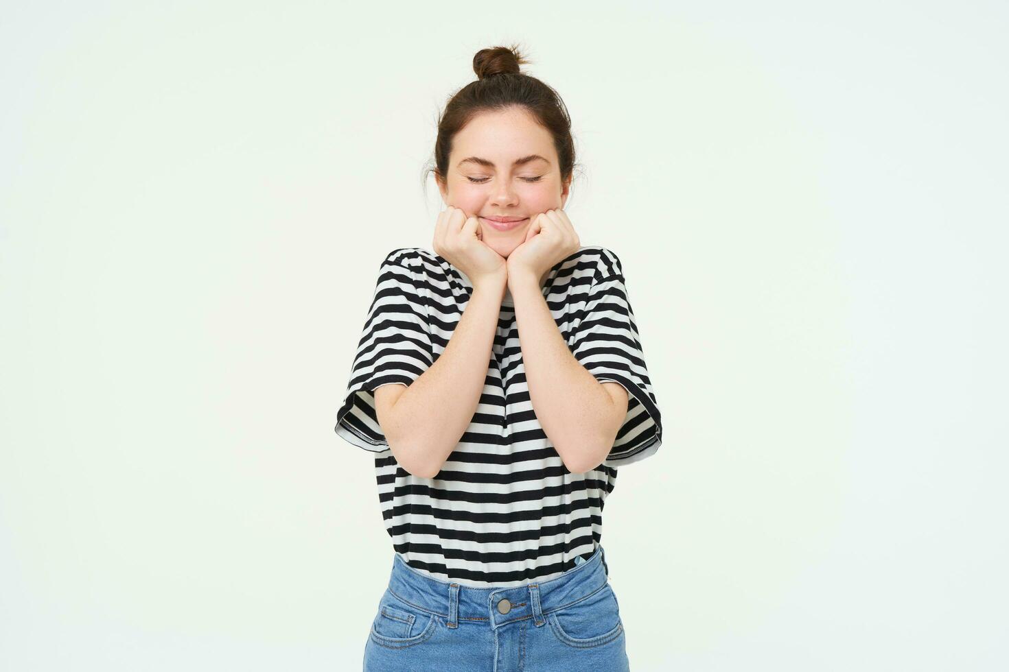 Portrait of beautiful, excited brunette woman, feeling excited and upbeat, smiling and looking happy, standing over white background photo
