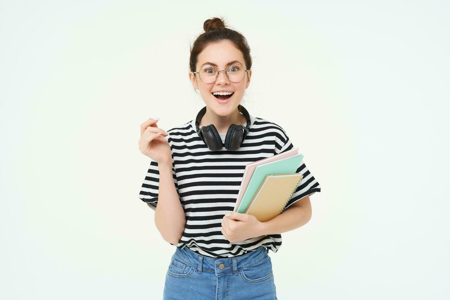 Student lifestyle and people concept. Portrait of young woman in glasses, teacher or college girl with books and study material, posing over white background photo