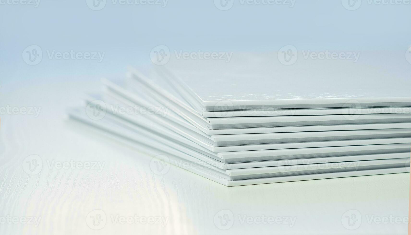 covers of photo books with clean empty white covers, close-up, partial blur