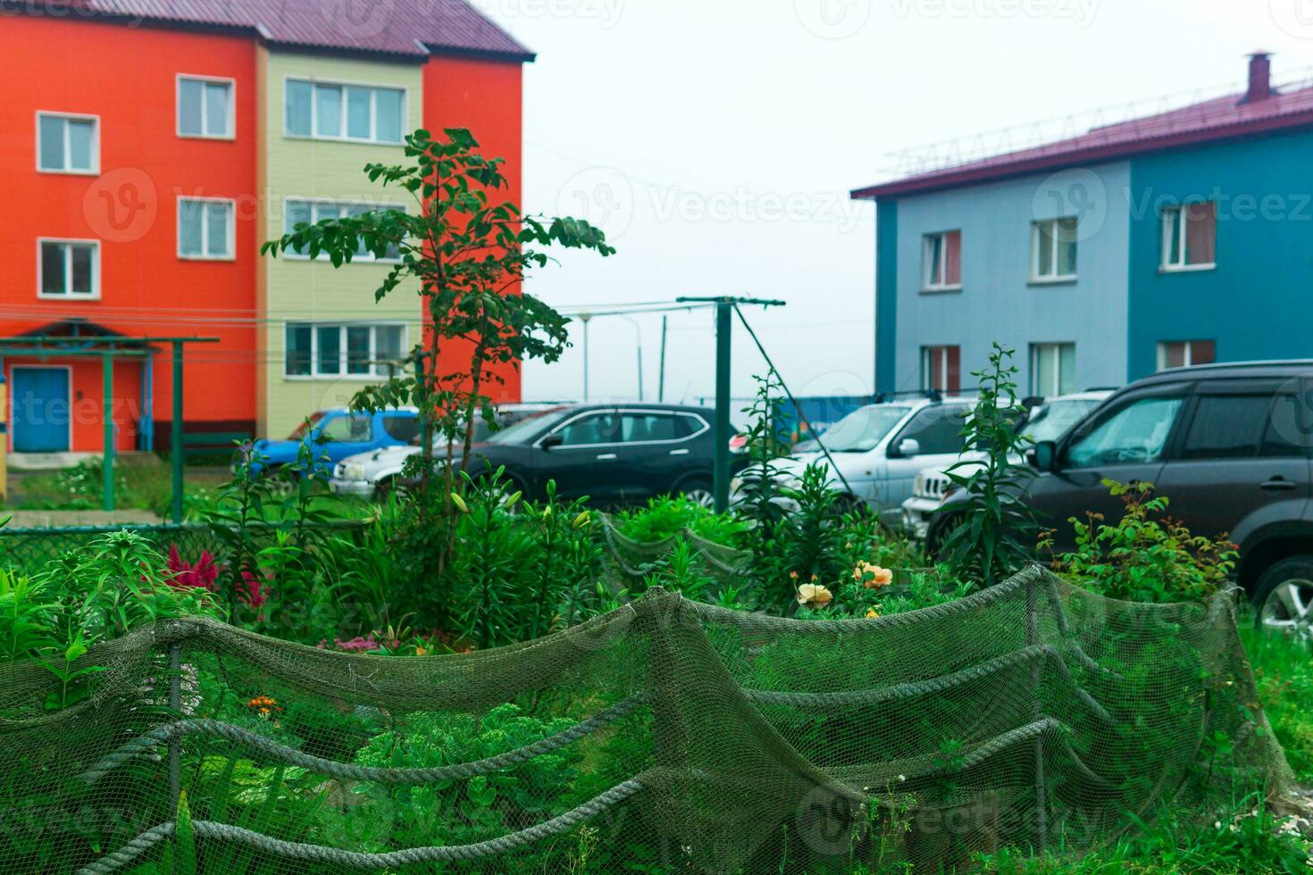 landscape design in a seaside village, a flower bed is fenced with an old fishing net photo