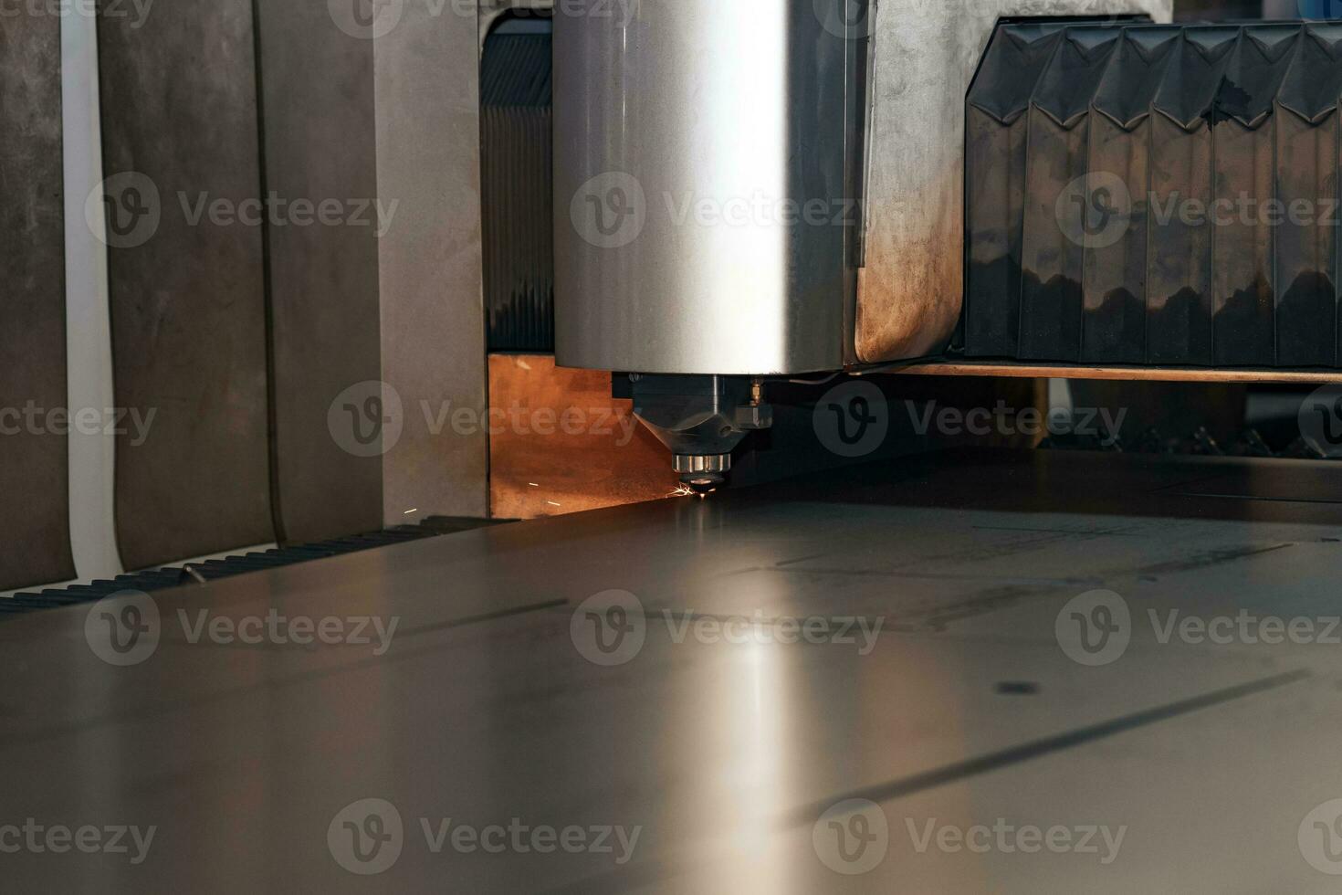 heavy industrial laser cutter during metal sheet processing photo