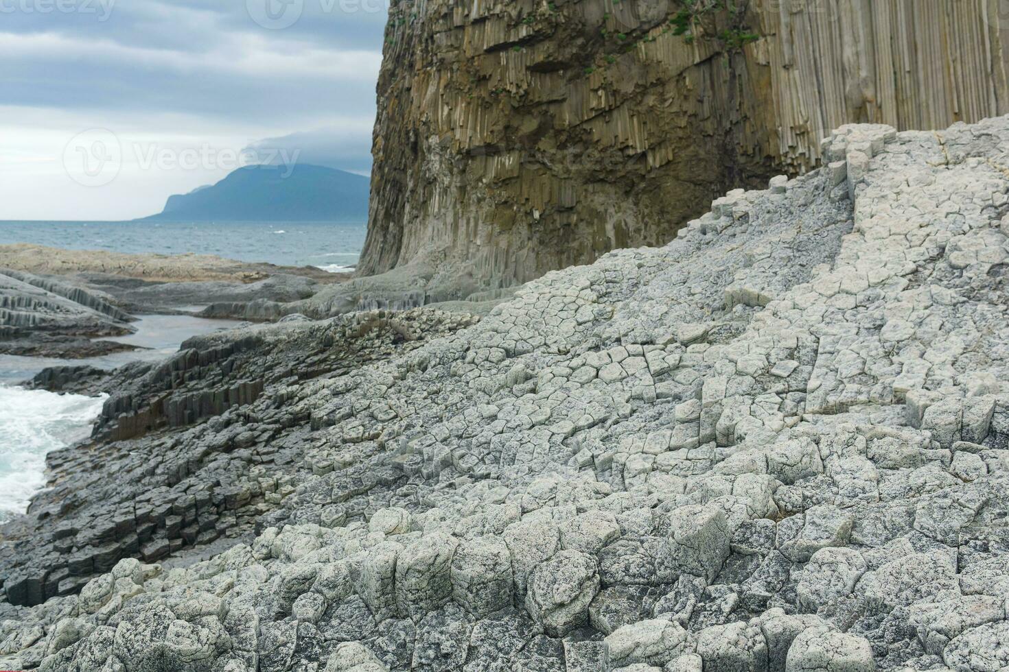 Columnar basalt rock, Cape Stolbchaty on Kunashir Island, in the foreground bases of lava basalt columns form a kind of pavement photo