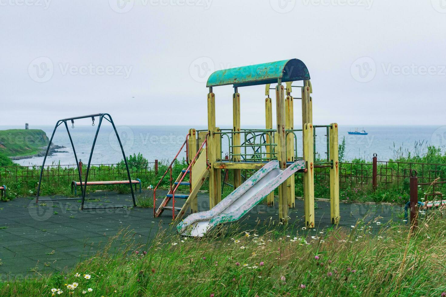old playground on an island by the sea photo
