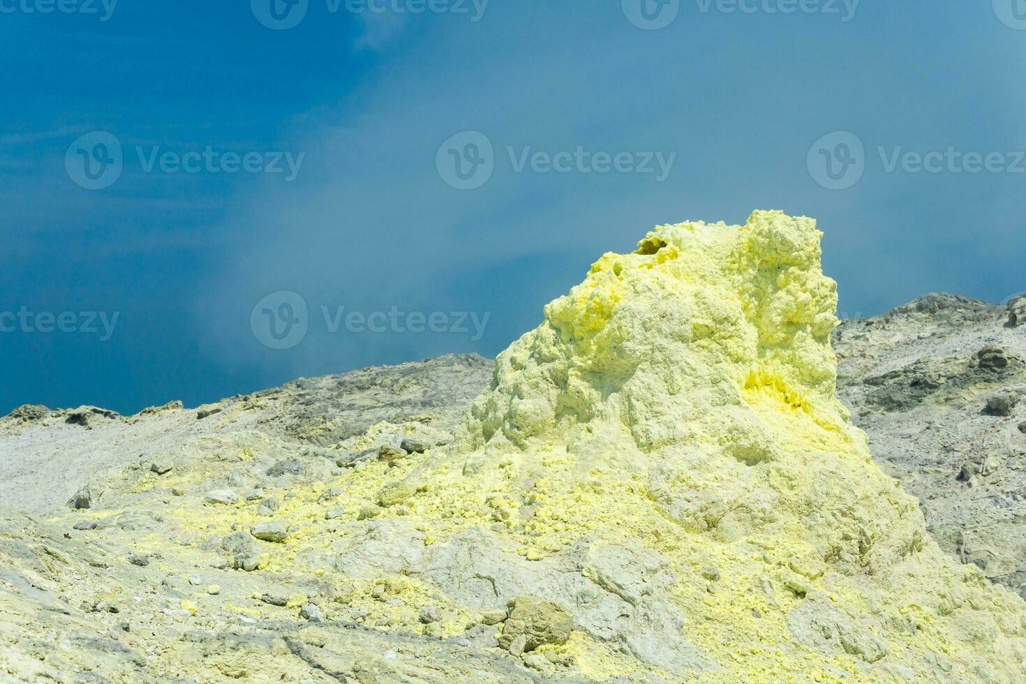 sulfur deposits around a solfatara in a fumarole field on the slope of a volcano photo