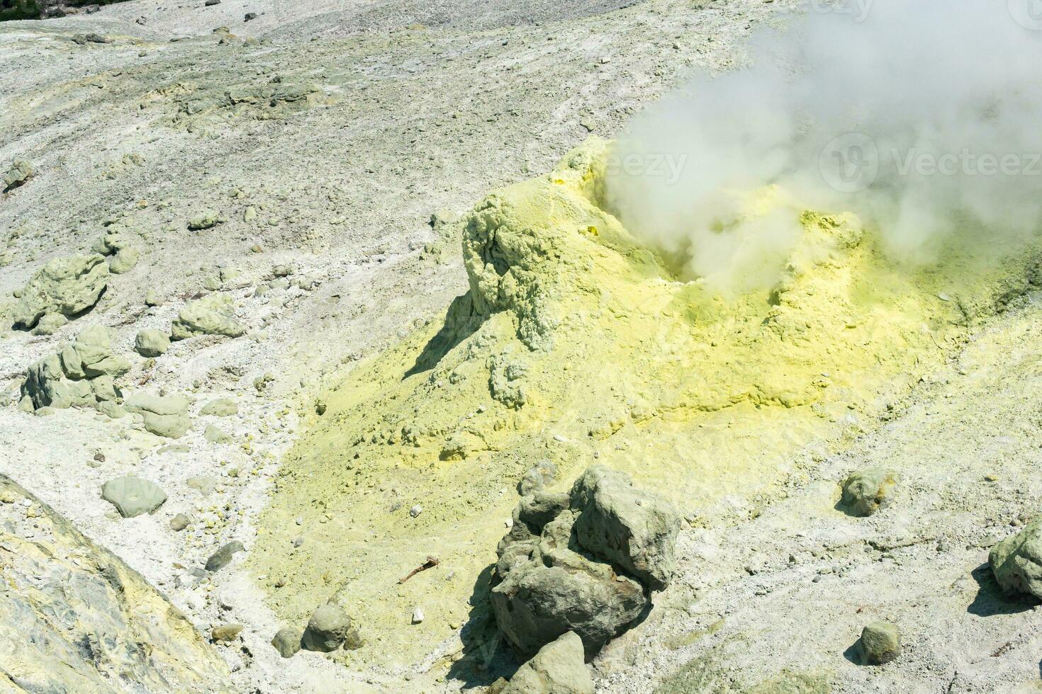 sulfur deposits around a solfatara in a fumarole field on the slope of a volcano photo