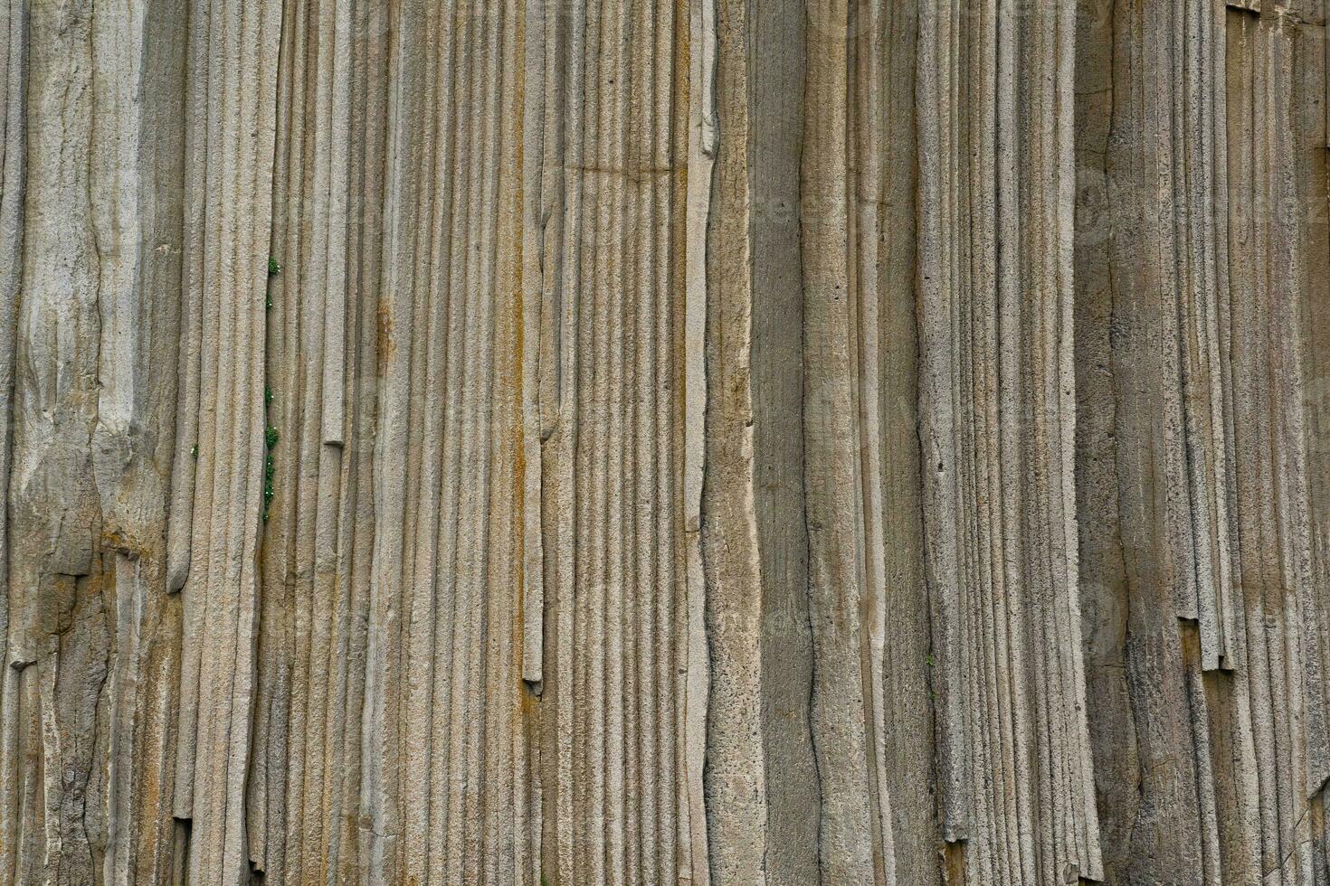 natural background, the surface of the rock, consisting of vertical basalt columns photo