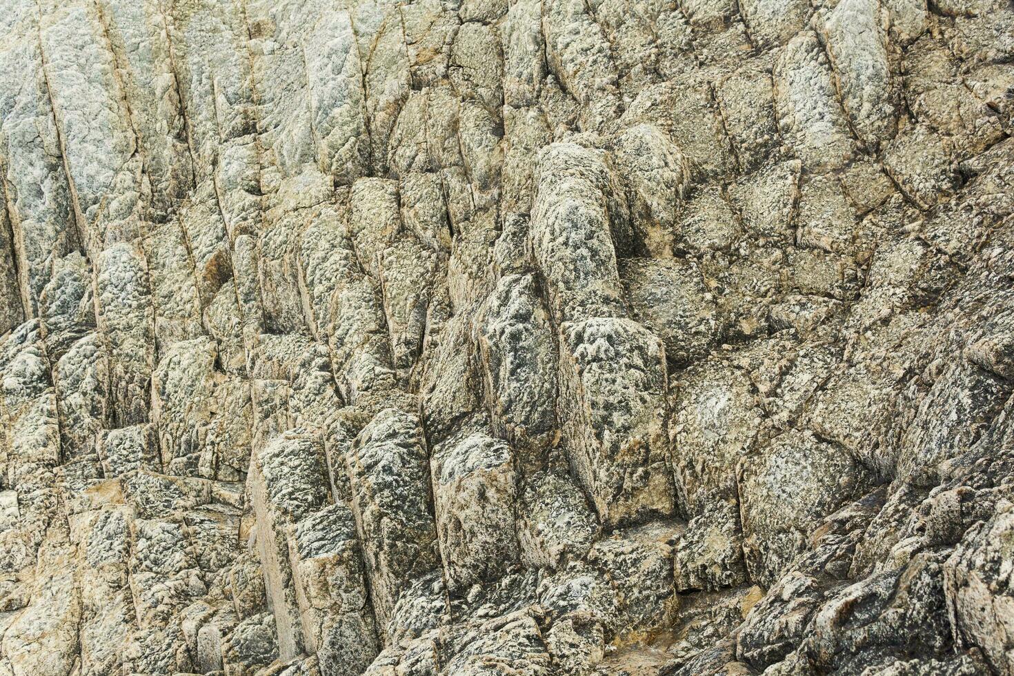 natural background, rock texture from weathered columnar basalt photo