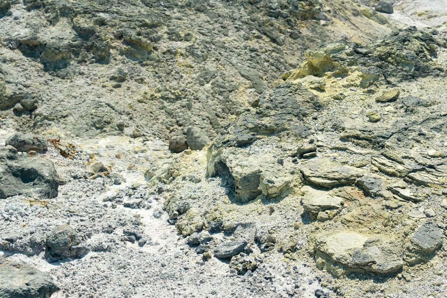 tephra soil with yellow deposits of sulfur minerals in the area of volcanic gases in the solfataric field photo