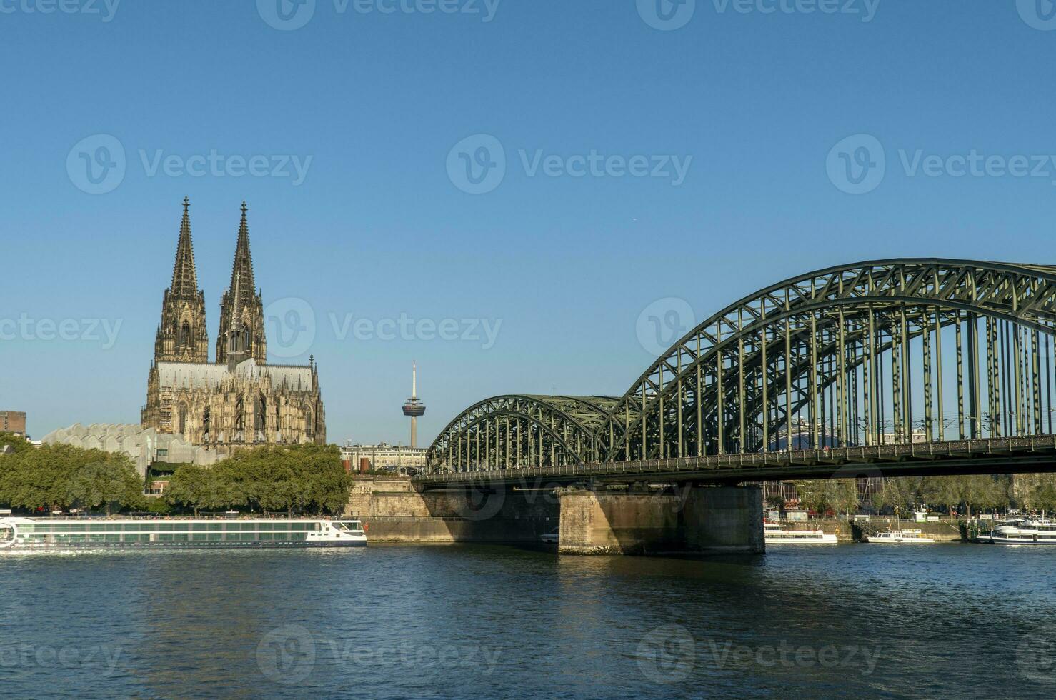 Cologne Cathedral and Hohenzollern Bridge daylight view photo