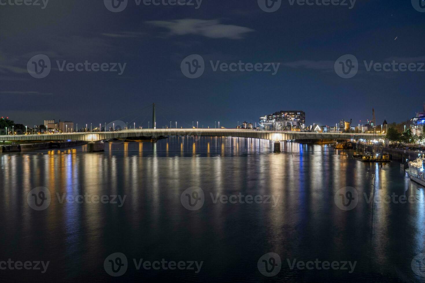 Evening view of the Deutz Bridge in Cologne, lights reflected in the Rhine photo