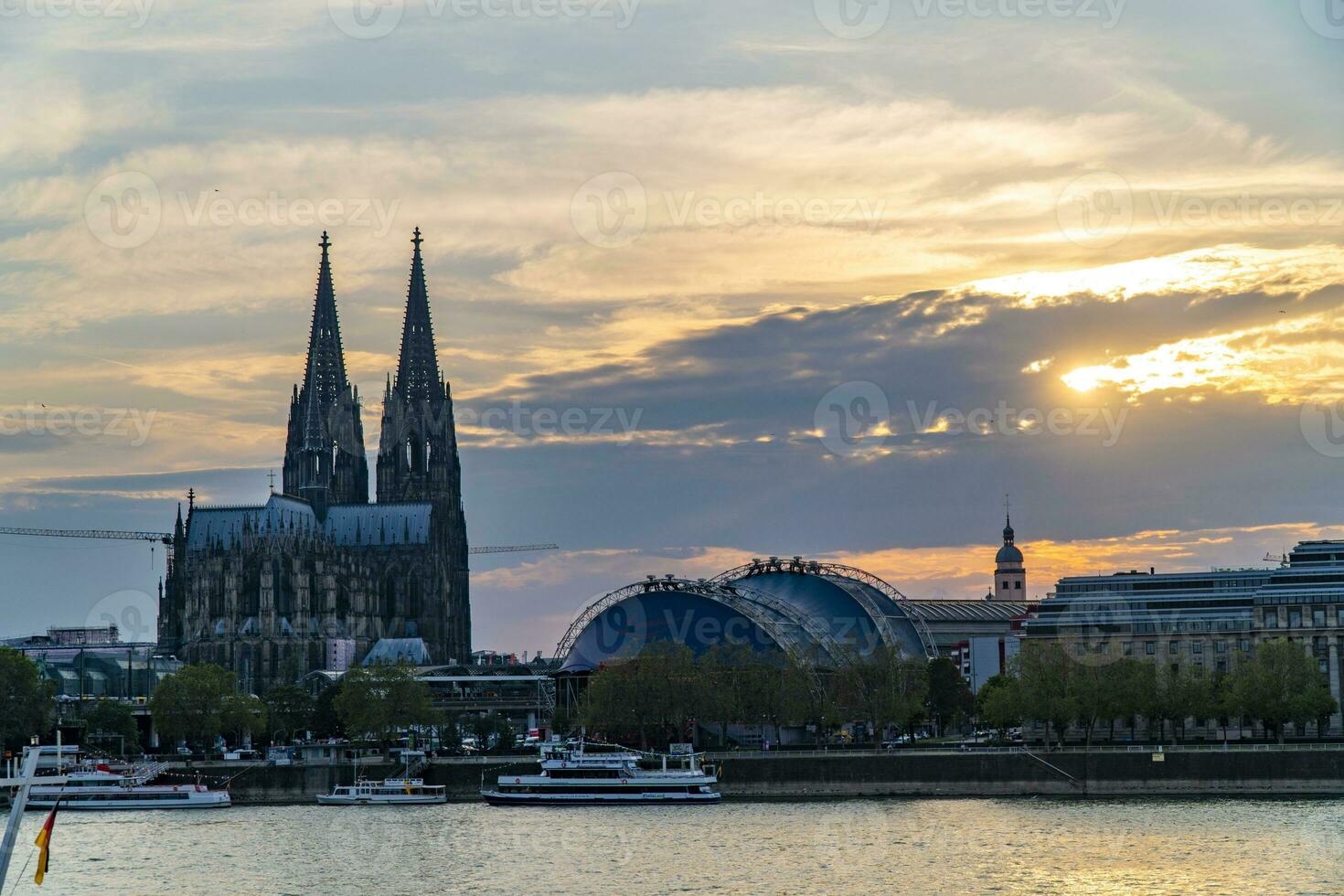 Evening silhouette view of Cologne Cathedral and Rhine river photo