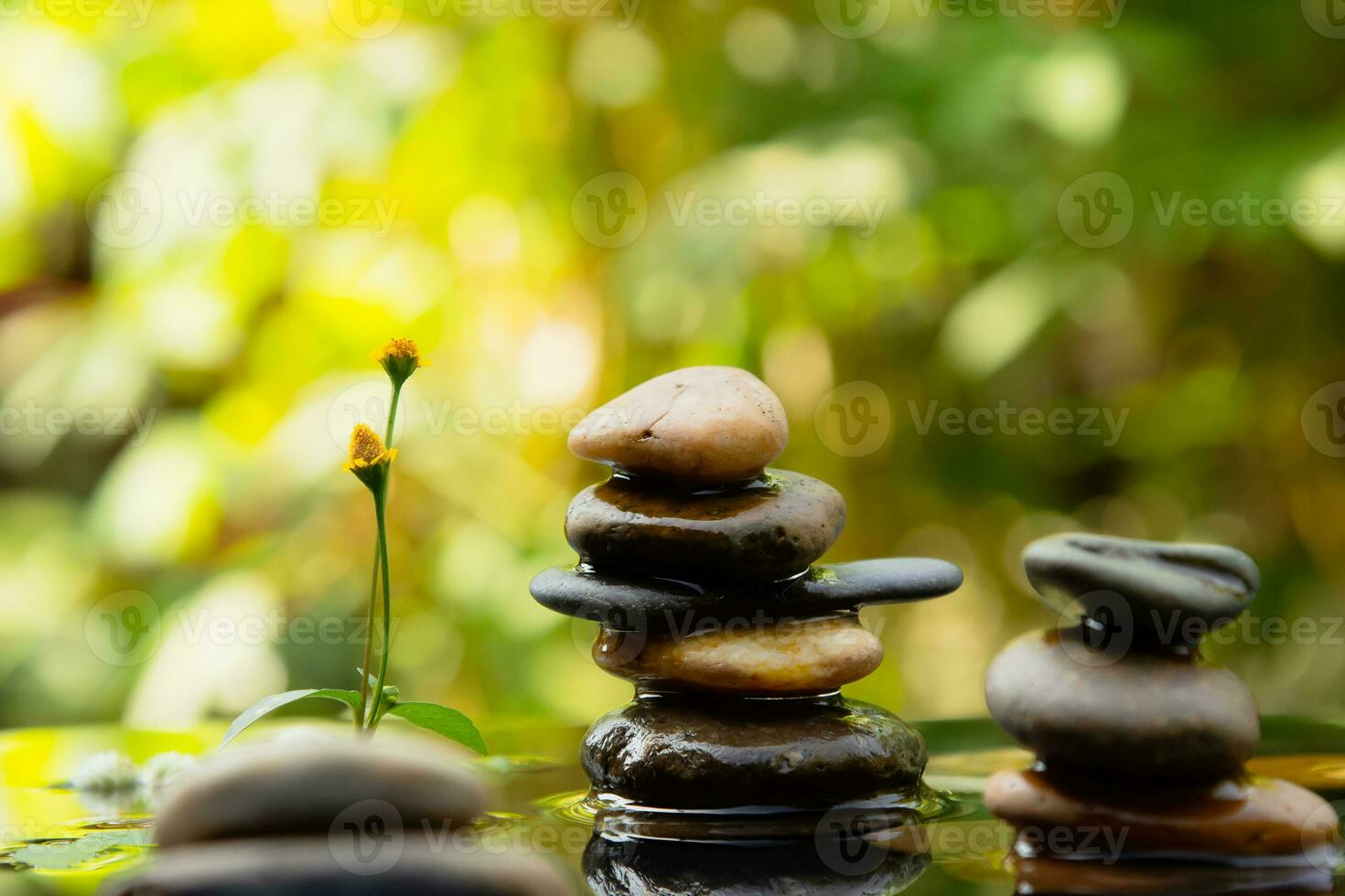 Relaxation and peace mood Balanced rocks pyramid on water with Golden light natural peace concepts bokeh on background photo