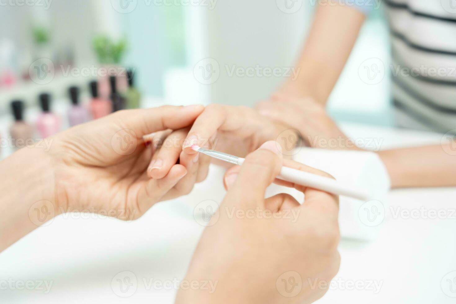 Woman receive care service by professional Beautician Manicure at spa centre. Nail beauty salon use nail file for Glazing treatment. manicurist make nail customer to beautiful. body care spa treatment photo