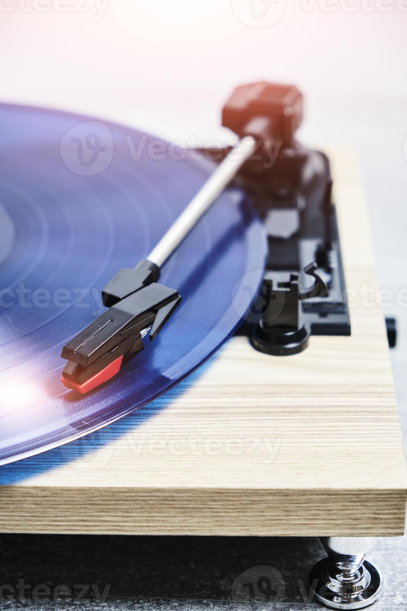 Classic vinyl record player closeup with contoured sunlight. 35916791