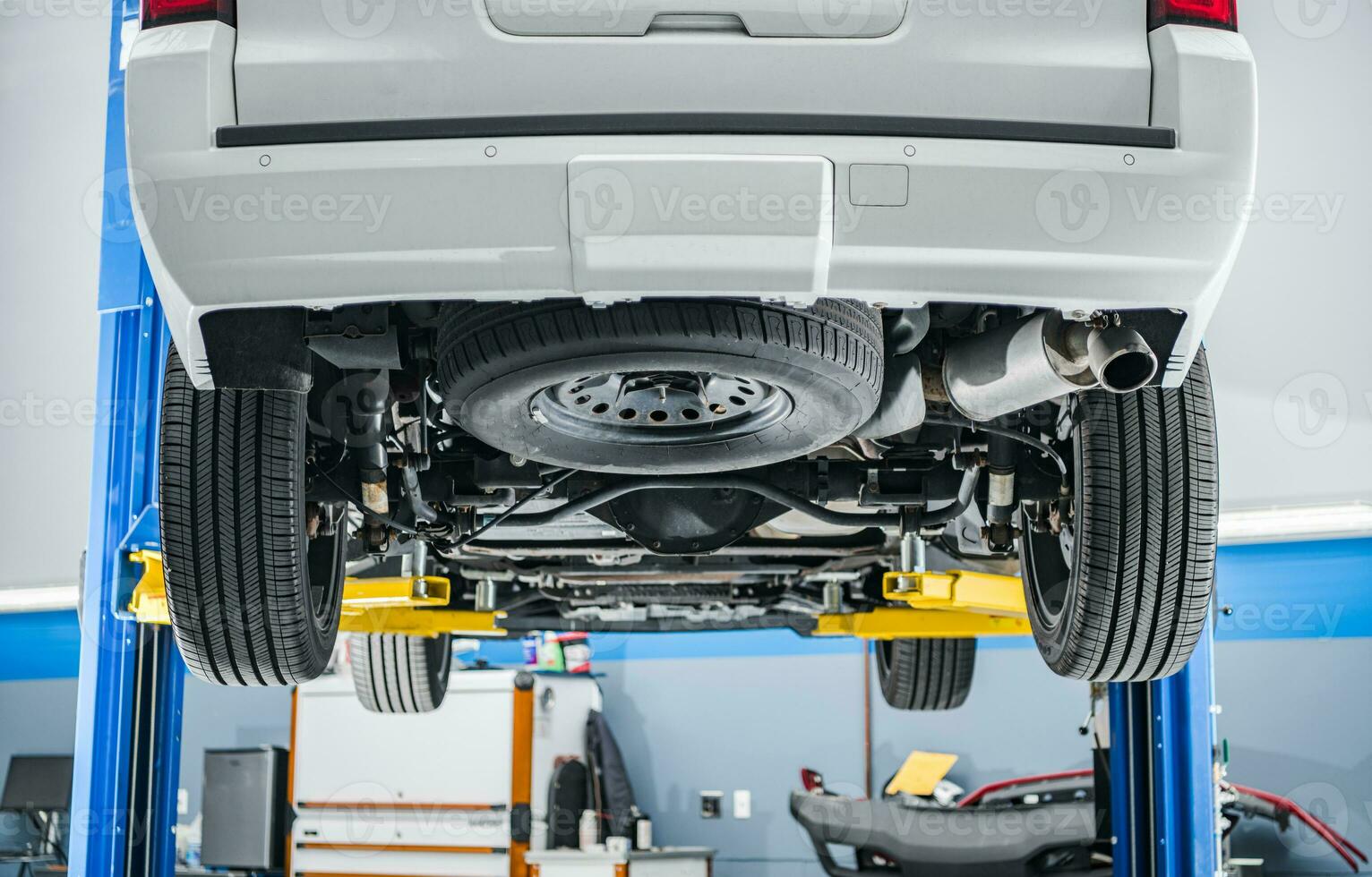 A Car on a Lift Inside Auto Service Shop photo