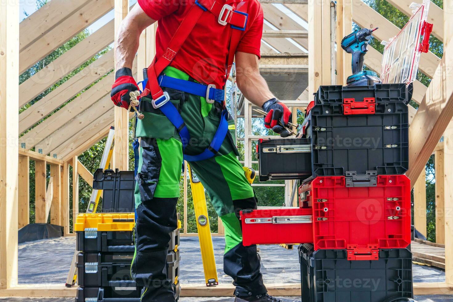 Construction Worker and Big Pile of His Tools and Equipment photo