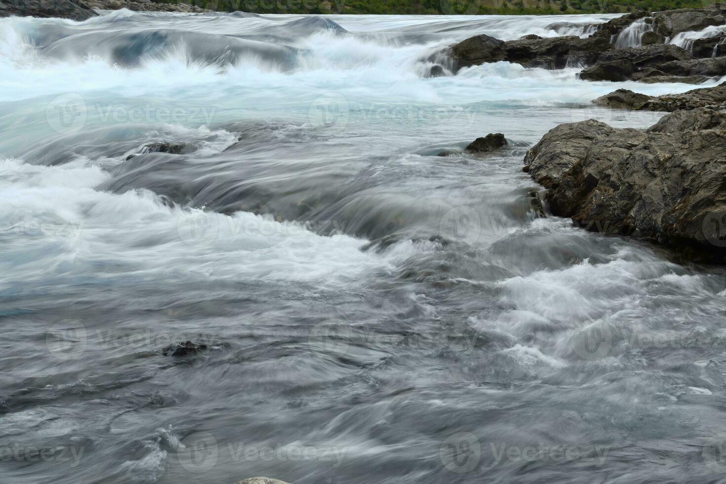 Rapids at the confluence of blue Baker river and grey Neff river, Pan-American Highway between Cochrane and Puerto Guadal, Aysen Region, Patagonia, Chile photo