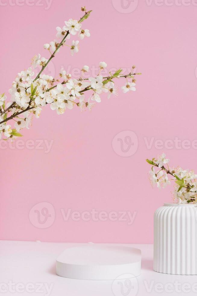 Empty podium or pedestal with spring bloom. Mock up for cosmetic products photo