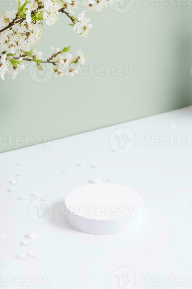 Empty podium or pedestal with spring bloom. Mock up for cosmetic products photo