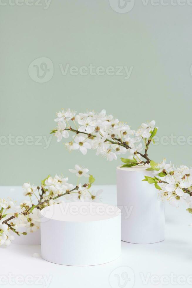 Empty podium or pedestal with spring bloom. Mock up for cosmetic products photo
