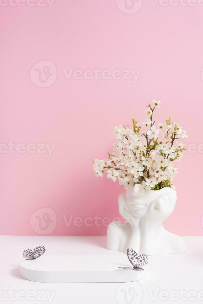 Empty podium or pedestal with spring bloom. Mock up for cosmetic products photo