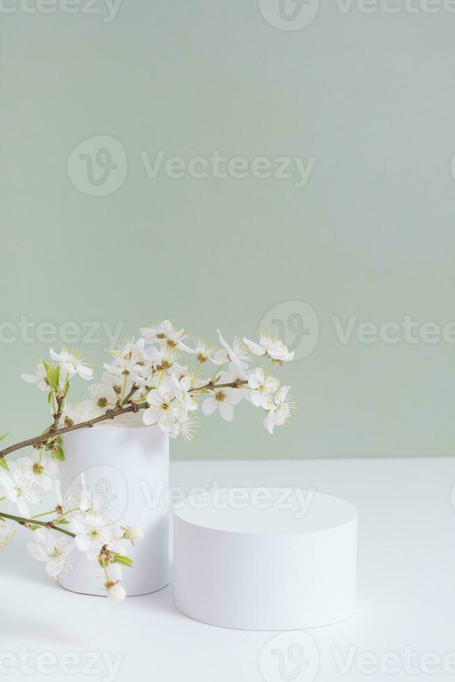 Empty podium or pedestal with spring bloom. Mock up for cosmetic products photo
