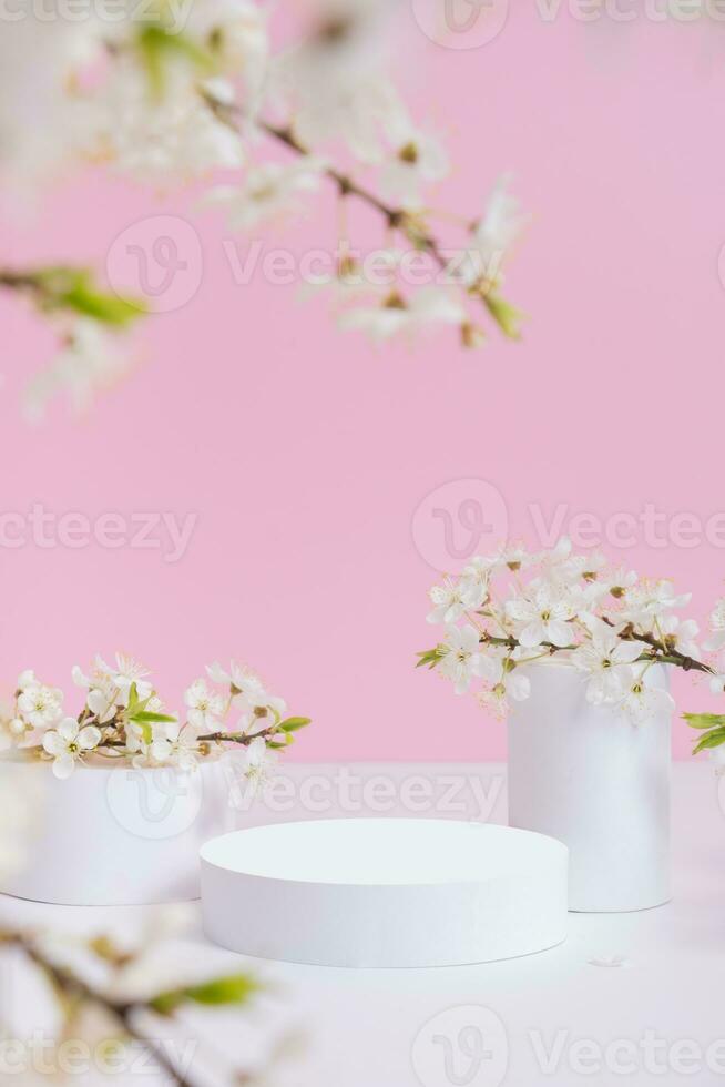 Empty podium or pedestal with spring bloom. Mock up for cosmetic products photo
