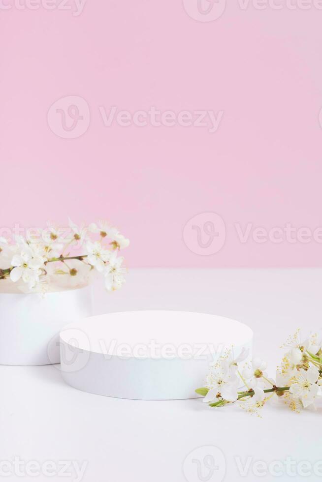 Empty podium or pedestal with spring bloom. Mock up for cosmetic products photo