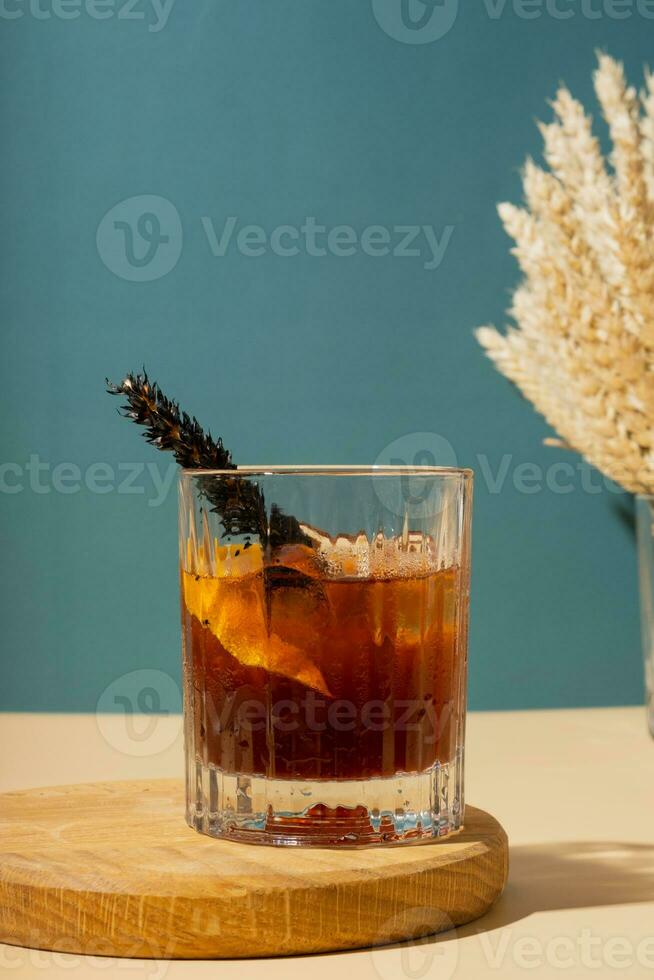 Alcoholic cocktail on a podium on a colored background photo