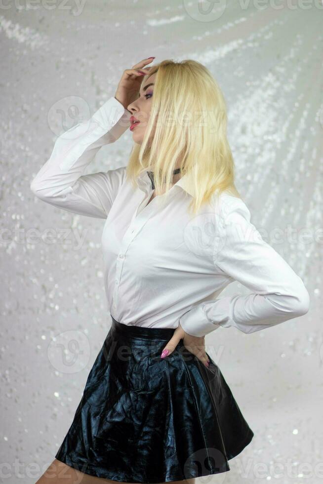 fashion blonde model woman in white shirt and black skirt photo