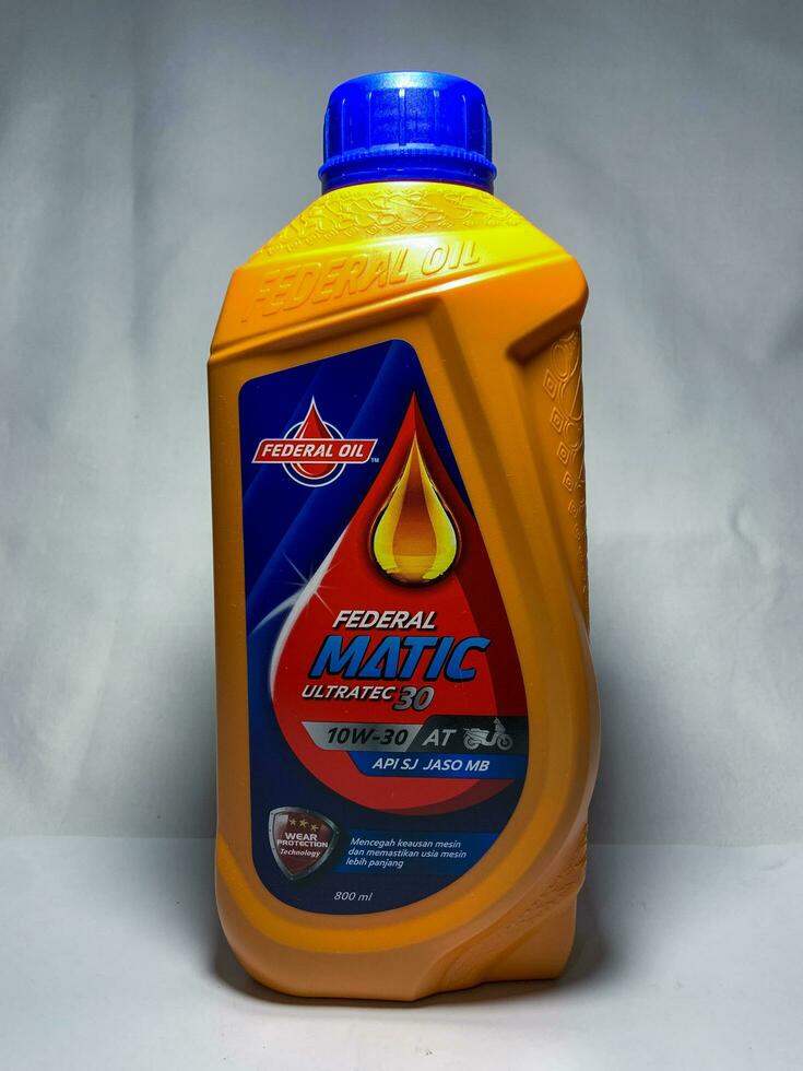 Sidoarjo, Indonesia, 2022 - Federal matic AT 10W-30 API SJ JASO MB 800 ml. Federal Oil. Plastic bottle of federal engine oil. Isolated on white background photo