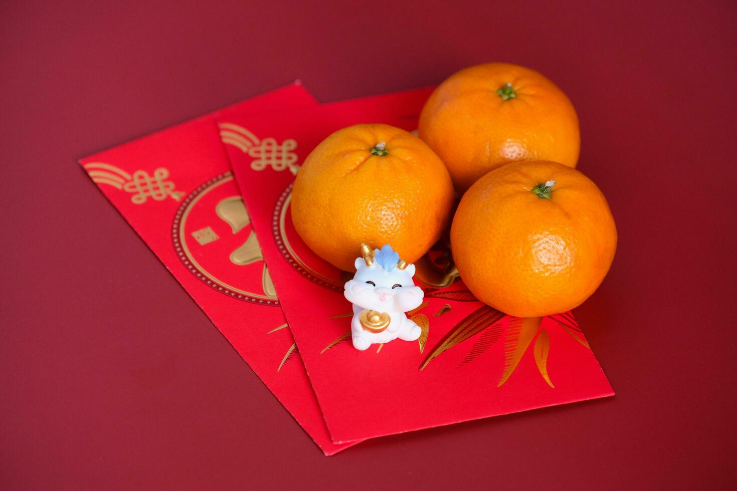 Happy New Year Chinese year of dragon 2024. Mandarin orange, dragon on red envelopes isolated on red background. photo