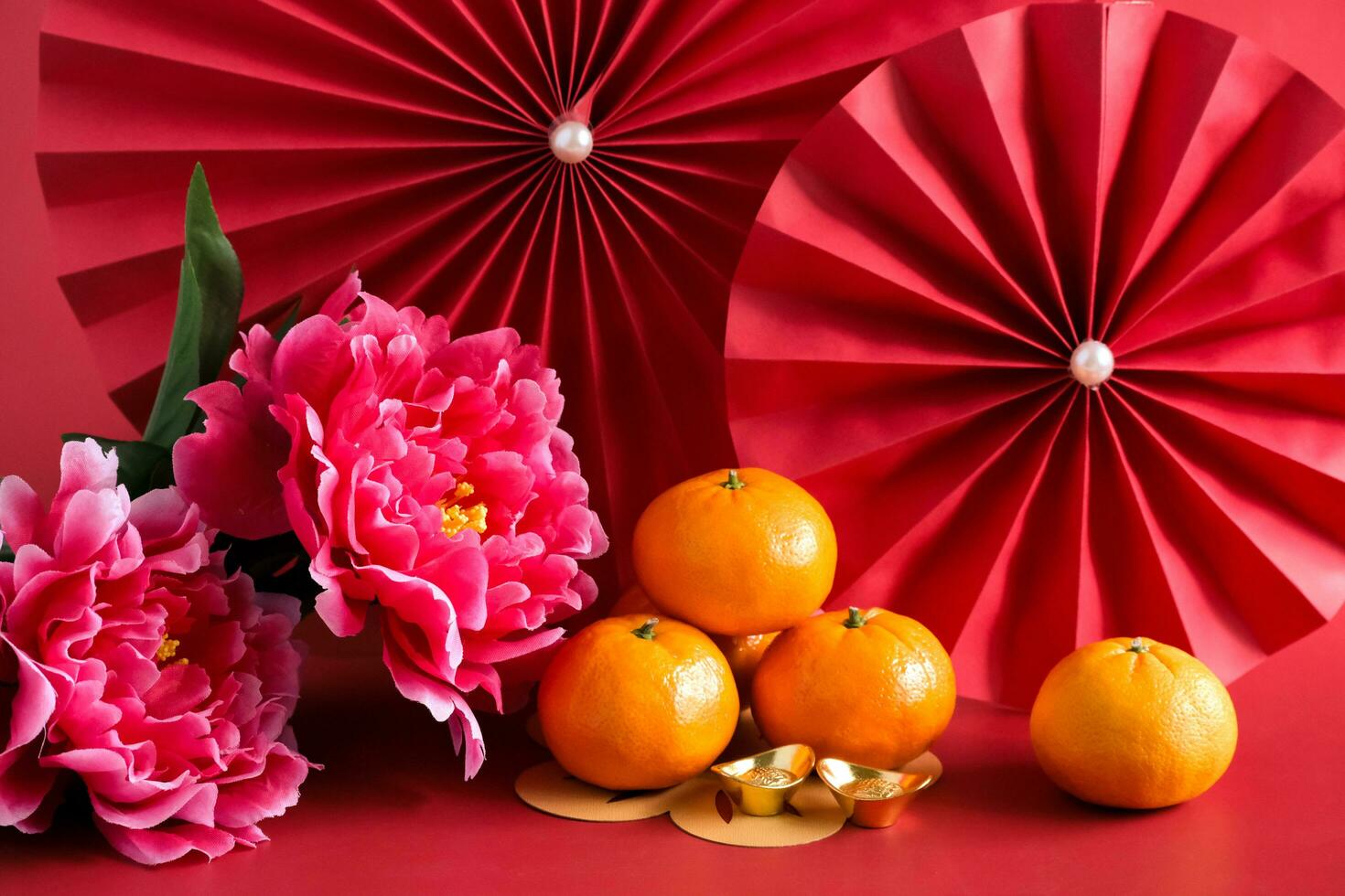 Chinese New Year of the dragon festival concept. Mandarin orange, red envelopes, dragon and gold ingot with red paper fans. Traditional holiday lunar New Year. photo