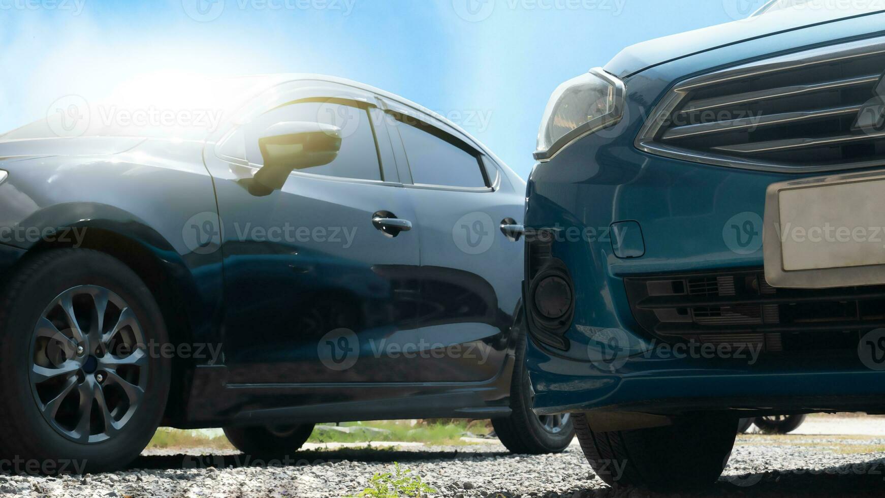 Transport front of blue car on the cobblestone road. with blurred of black car beside. under blue sky. photo