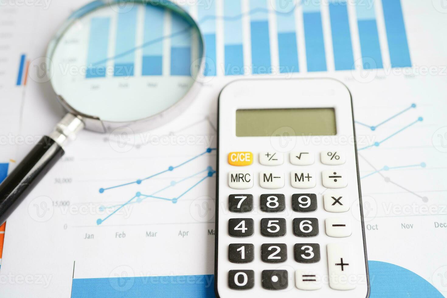 Magnifying glass on charts graphs paper. Financial development, Banking Account, Statistics, Investment Analytic research data economy. photo