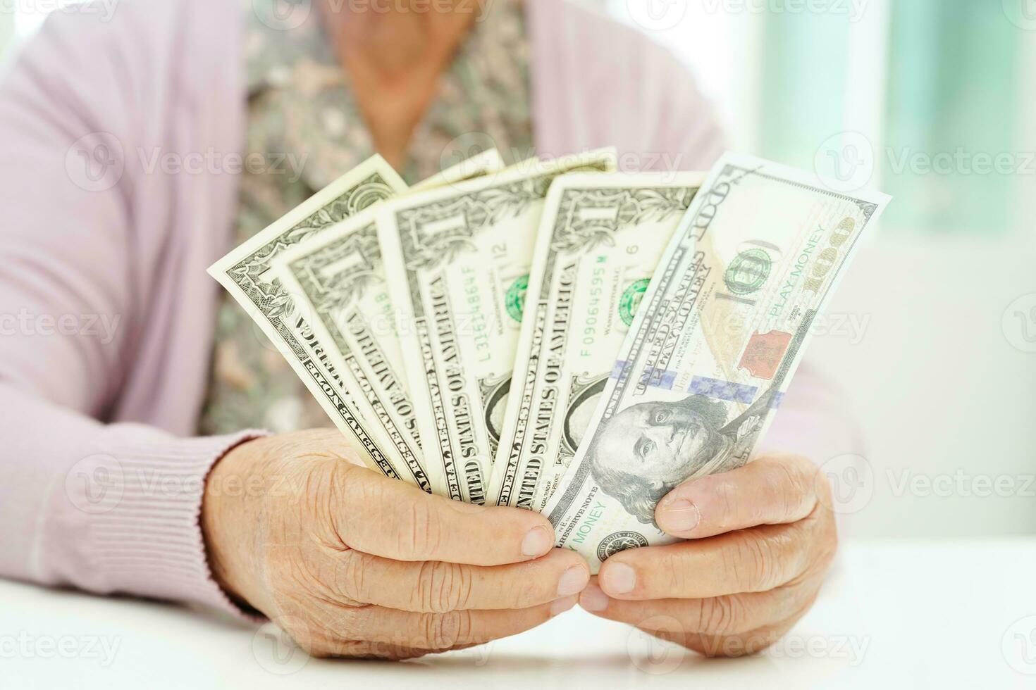 Retired elderly woman counting coins money and worry about monthly expenses and treatment fee payment. photo