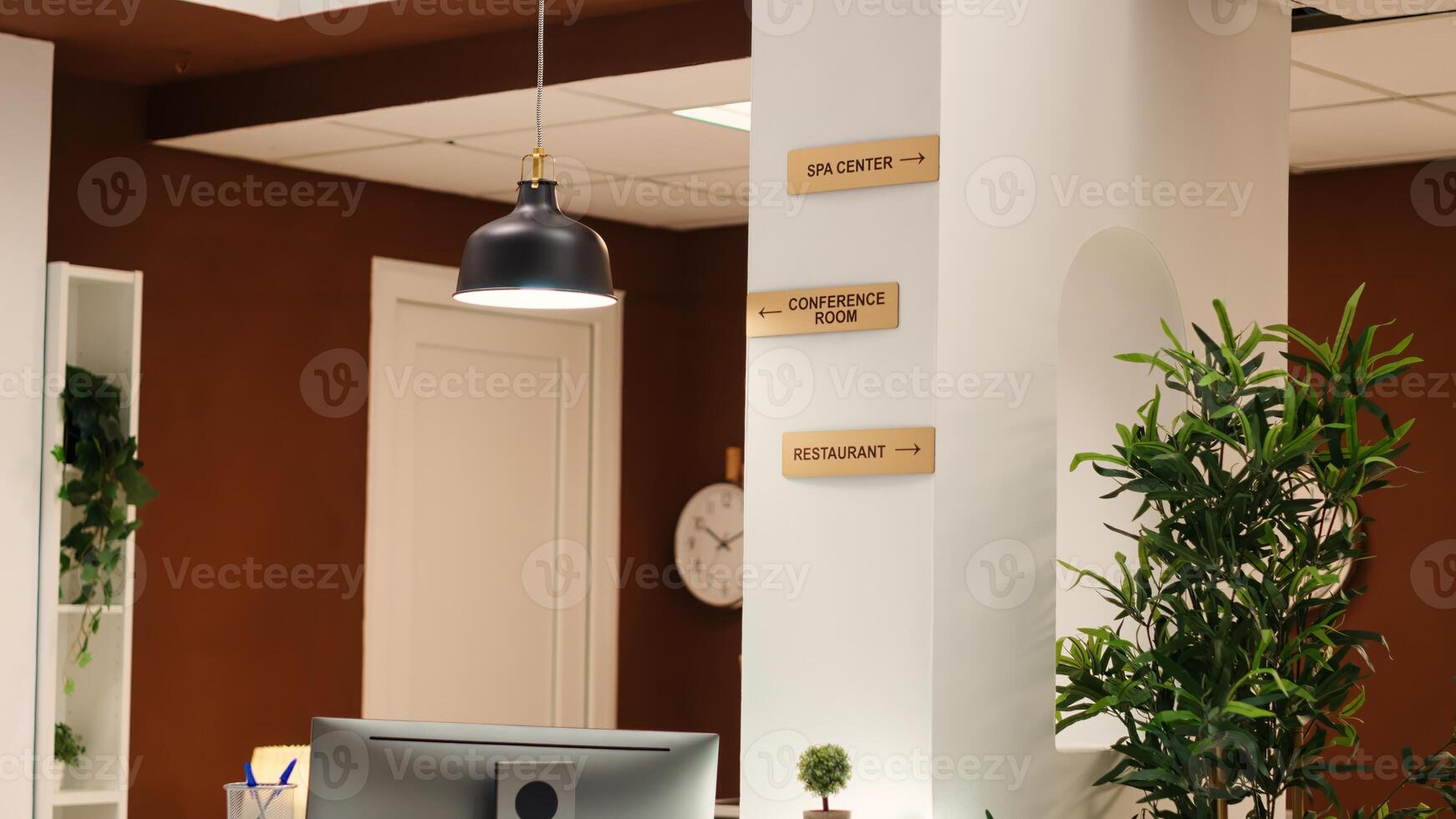 Close up of resort facilities plaque signs on lounge wall. Panning shot of empty stylish business hotel lobby interior with luxurious deluxe spa center, conference room, and restaurant amenities photo