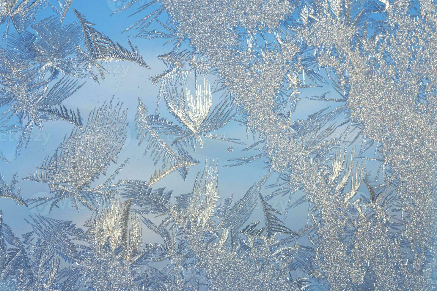 Abstract frosty pattern on glass, background ice texture photo